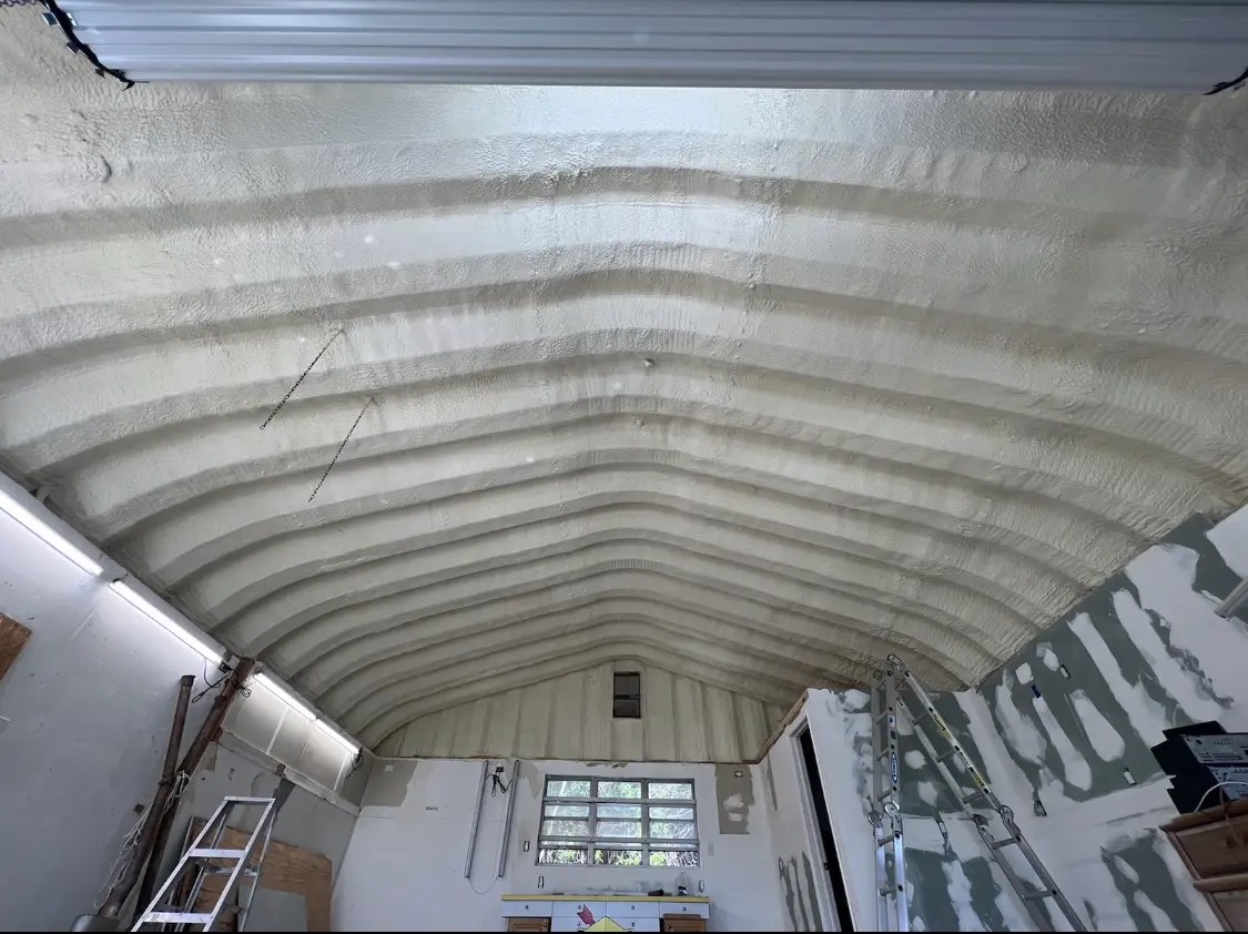 Spray polyurethane foam applied to the underside of a metal roof deck in Saratoga